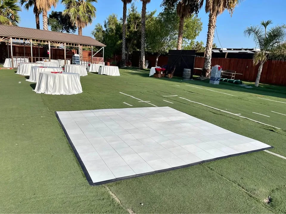 Pista de baile blanca instalada en un jardín para evento